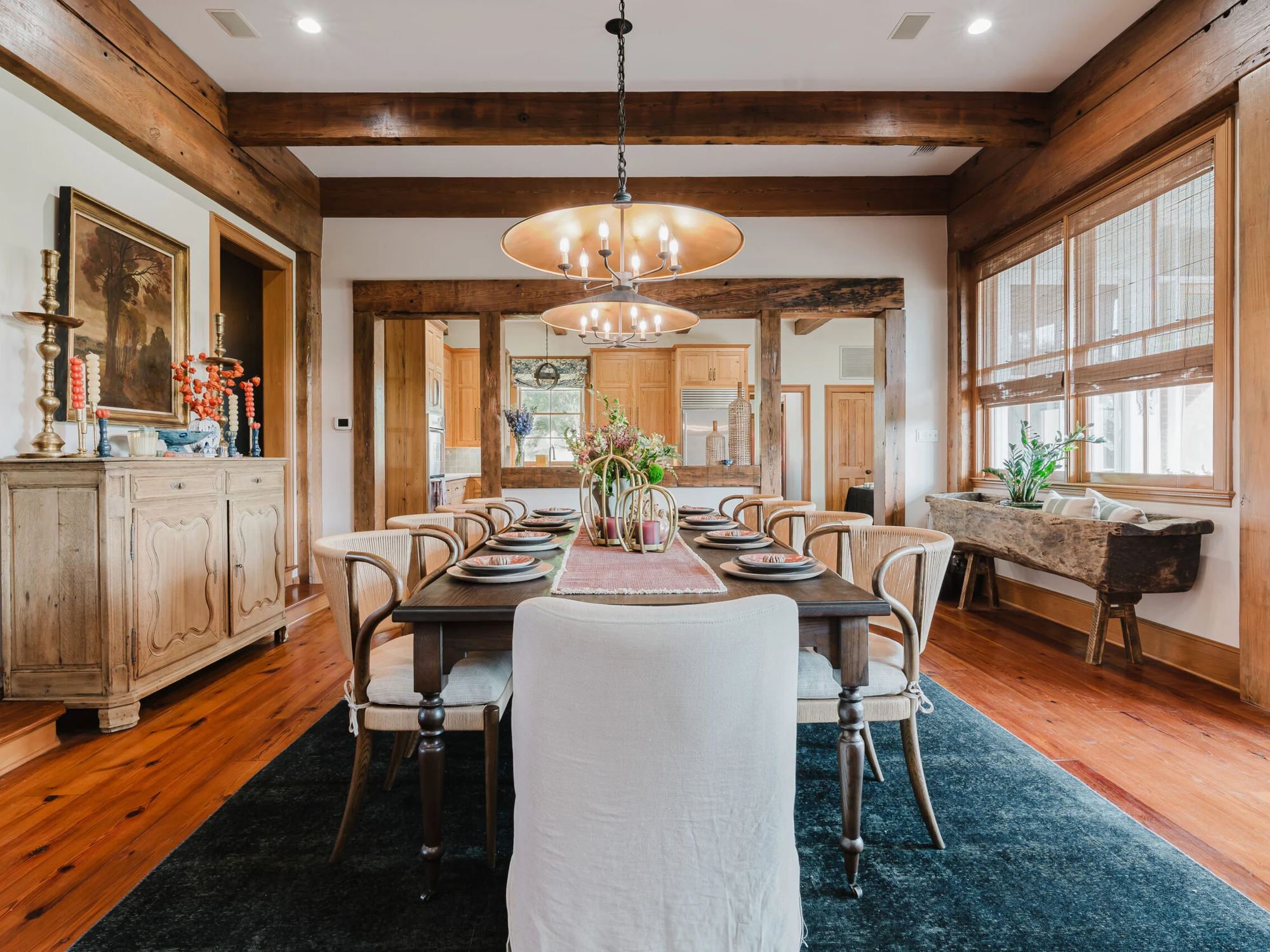 Dining room with a chandelier and wood beams